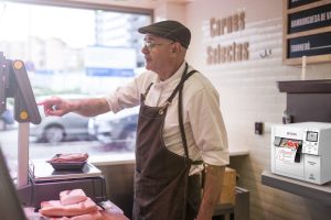 butcher weighing the meat and charging