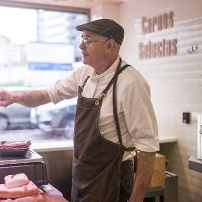 butcher weighing the meat and charging