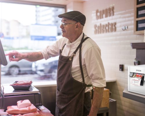 butcher weighing the meat and charging